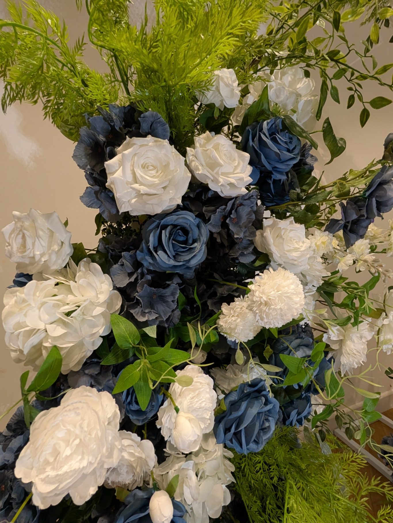 Isabella - Detail Arrangement of blue and white roses with greenery.