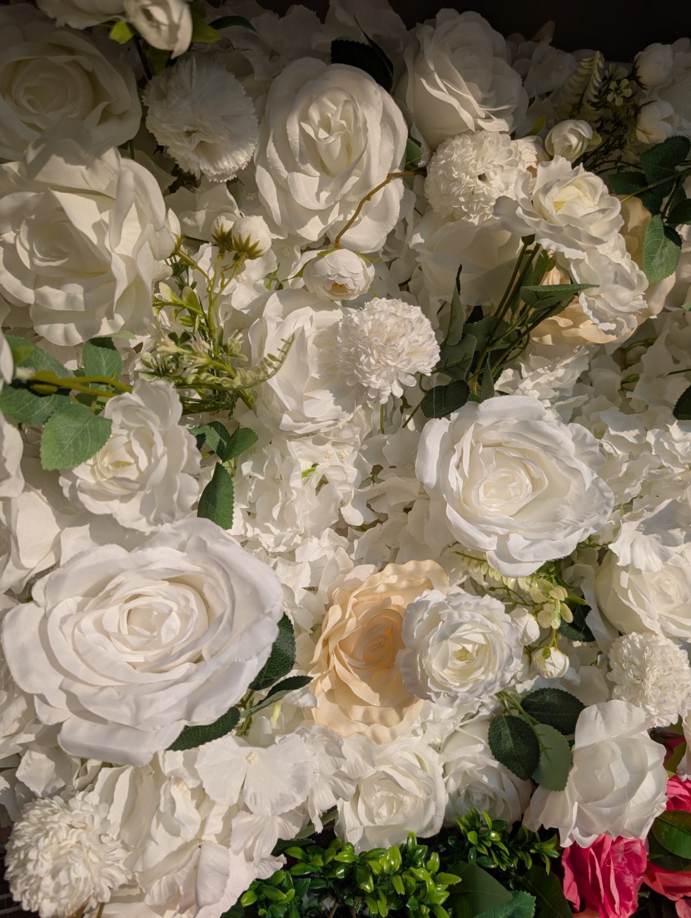 Joy - Detail during the golden hour A dense arrangement of white roses and various cream-coloured flowers.