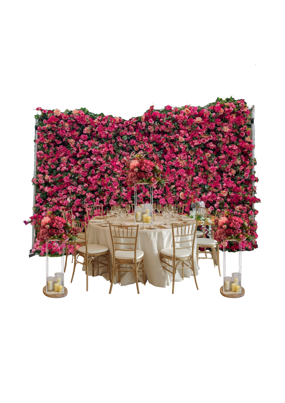 Large Flower Wall Edith with Matching Centrepieces Elegant table setup with gold chairs, surrounded by a vibrant floral backdrop.