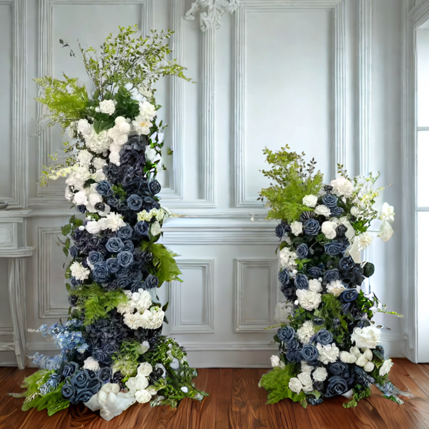 Isabella - Broken Arch Tall floral arrangements with white and blue flowers, set against a light, elegant interior.