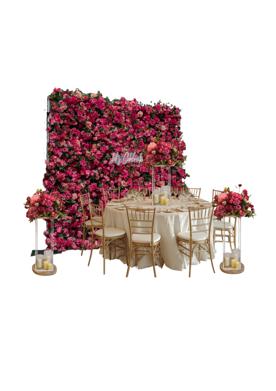 Classic Flower Wall Edith with Matching Centrepieces Elegant dining setup with a floral backdrop and decorative table arrangements.