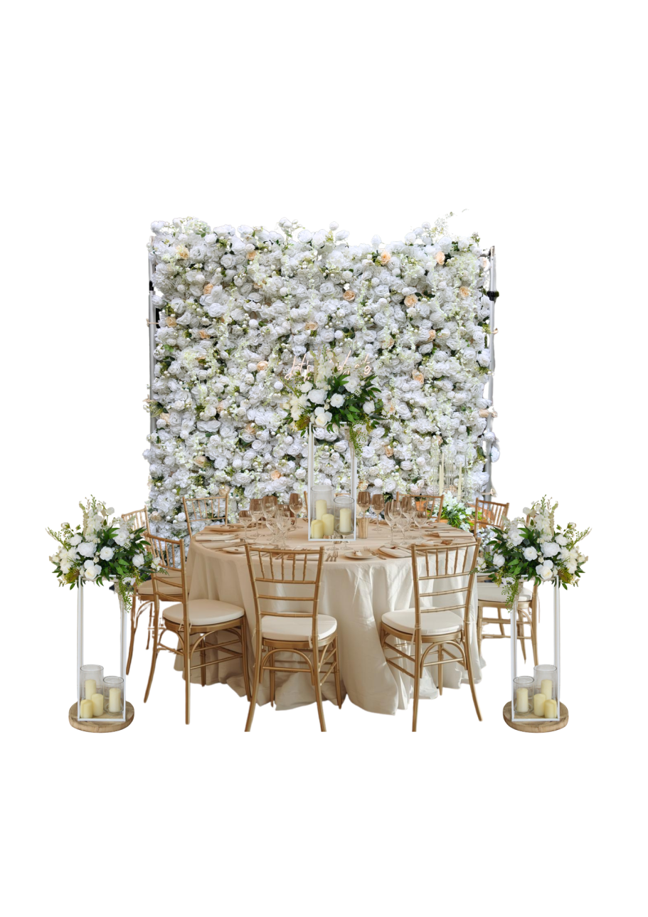 Classic Flower Wall Joy with Matching Centrepieces Elegant dining setup with a floral backdrop, wooden chairs, and centrepieces.